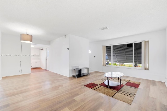 living room with wood finished floors and visible vents
