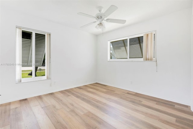 empty room with a ceiling fan, baseboards, and light wood-type flooring