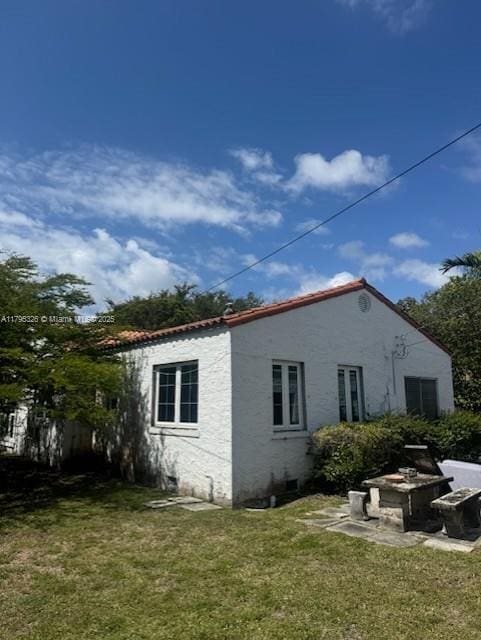 view of side of property with a yard