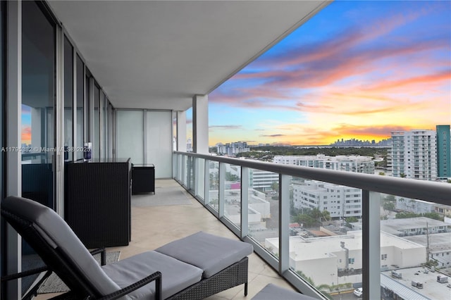 balcony at dusk with a view of city