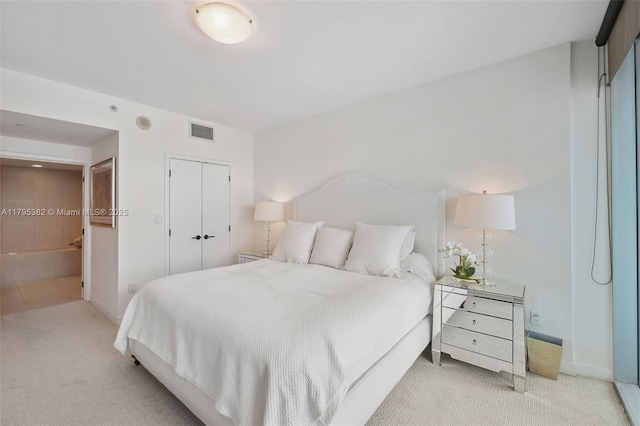 bedroom with carpet floors, baseboards, a closet, and visible vents