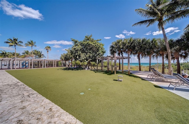 surrounding community featuring a water view and a pergola