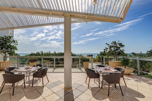 view of patio / terrace with a pergola, a water view, and outdoor dining area
