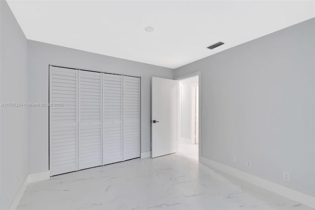8055 Sweetbriar Way, Boca Raton, FL 33496 - unfurnished bedroom with baseboards, visible vents, marble finish floor, and a closet