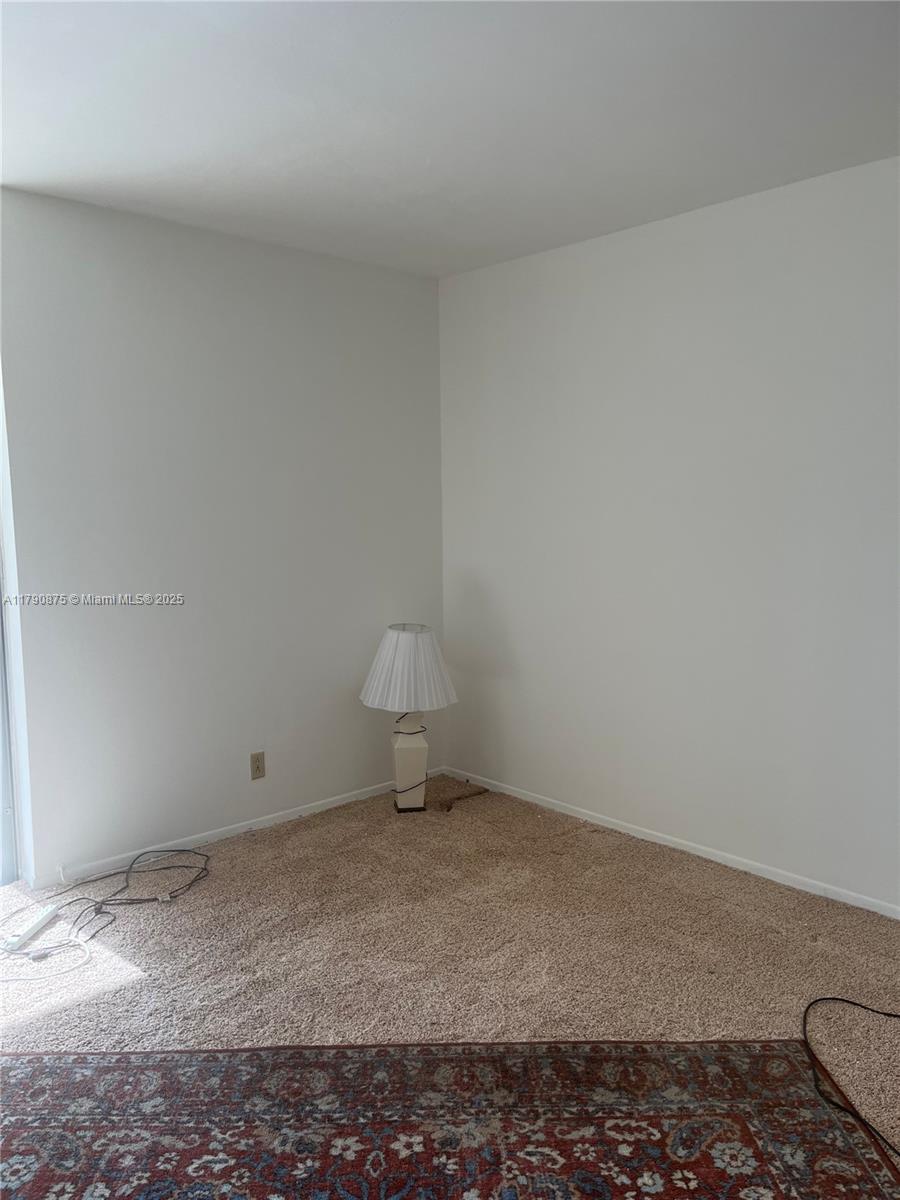 701 Three Islands Blvd Unit 409, Hallandale Beach, FL 33009 - carpeted spare room featuring baseboards