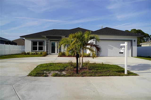 single story home featuring an attached garage, stucco siding, driveway, and fence