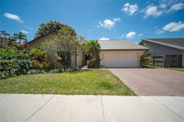 13150 SW 106th St, Miami, FL 33186 - view of front of property with fence, an attached garage, stucco siding, a front yard, and decorative driveway