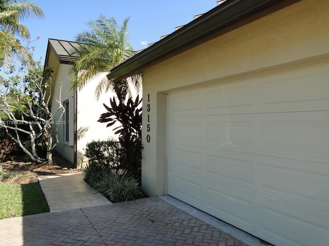 13150 SW 106th St, Miami, FL 33186 - view of side of property featuring driveway and stucco siding