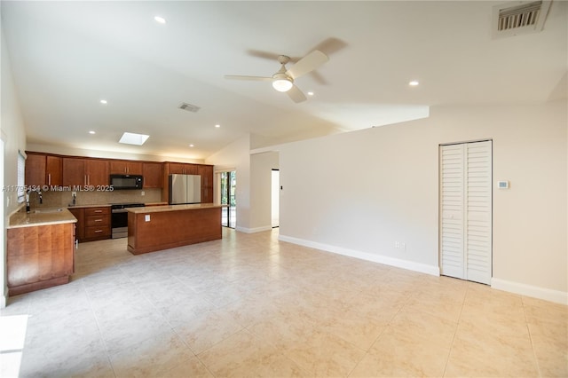 13150 SW 106th St, Miami, FL 33186 - kitchen with visible vents, electric stove, black microwave, and freestanding refrigerator
