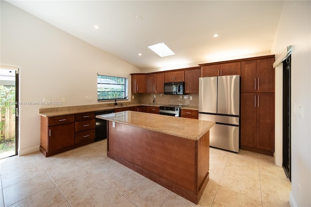 13150 SW 106th St, Miami, FL 33186 - kitchen with a kitchen island, lofted ceiling with skylight, a sink, backsplash, and black appliances