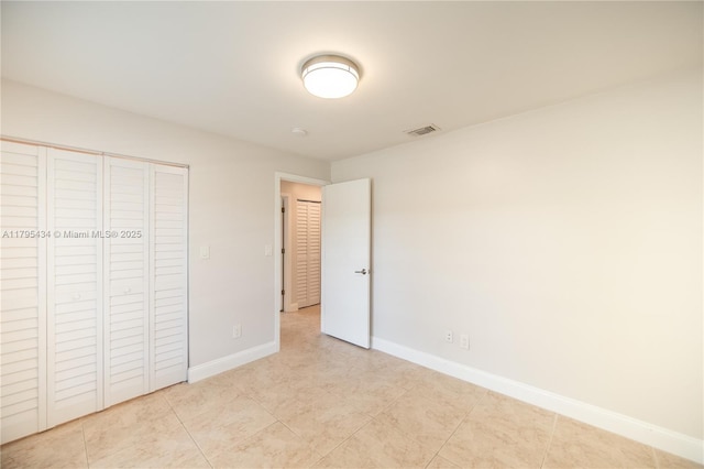 13150 SW 106th St, Miami, FL 33186 - unfurnished bedroom with visible vents, baseboards, light tile patterned floors, and a closet
