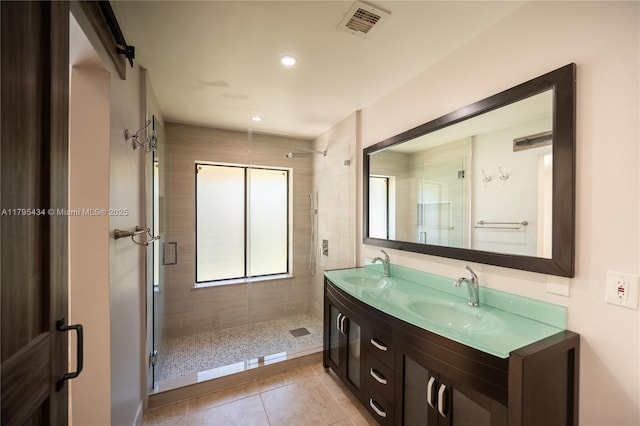 13150 SW 106th St, Miami, FL 33186 - bathroom featuring double vanity, visible vents, a stall shower, a sink, and tile patterned floors