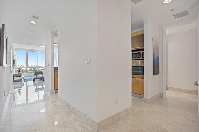hallway with baseboards, recessed lighting, marble finish floor, and visible vents