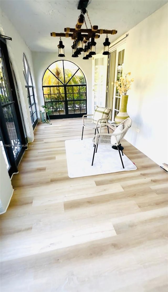 interior space featuring wood finished floors and a chandelier