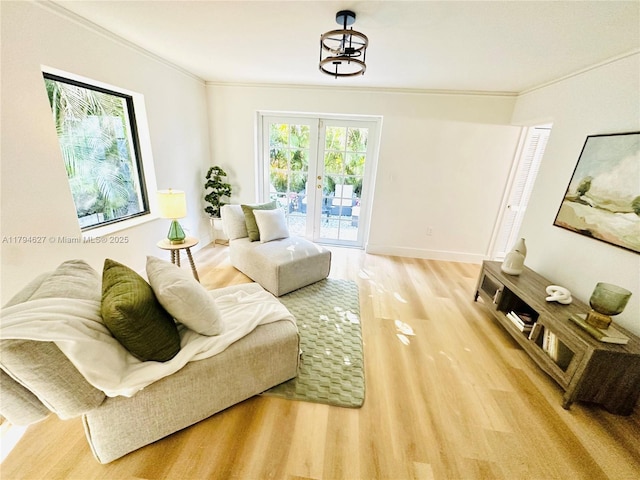 living area with crown molding and light wood-type flooring