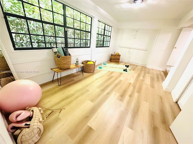 sitting room featuring baseboards and wood finished floors