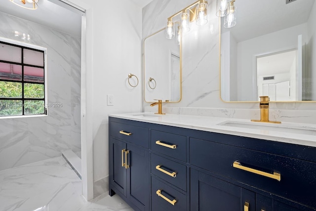 bathroom featuring double vanity, a sink, marble finish floor, and a marble finish shower