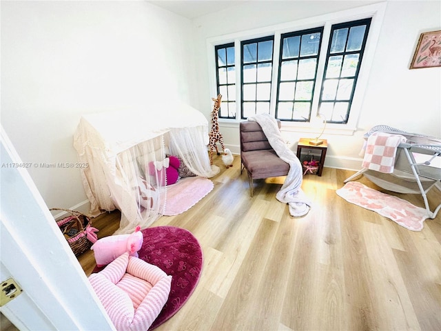 bedroom featuring baseboards and wood finished floors