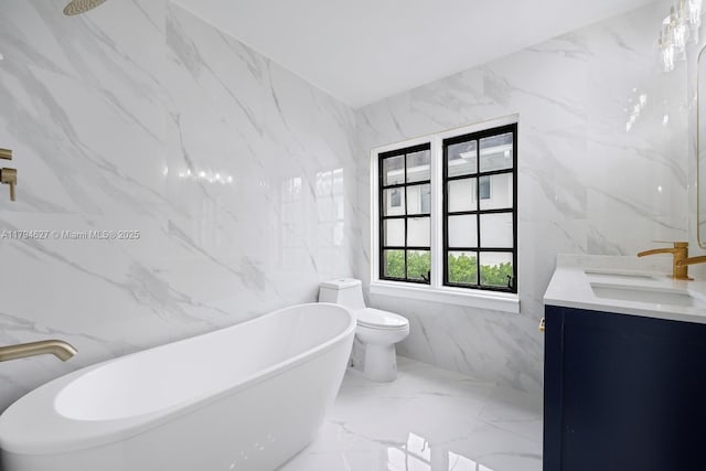 bathroom with vanity, toilet, marble finish floor, tile walls, and a soaking tub