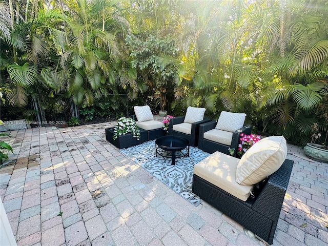 view of patio / terrace featuring an outdoor living space with a fire pit