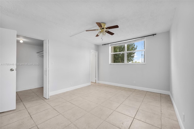 2861 Somerset Dr Unit 104, Lauderdale Lakes, FL 33311 - unfurnished bedroom featuring light tile patterned floors, ceiling fan, and a textured ceiling