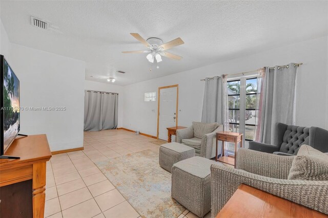9240 Nautilus Dr, Cutler Bay, FL 33189 - living room featuring a ceiling fan, a textured ceiling, visible vents, light tile patterned floors, and baseboards