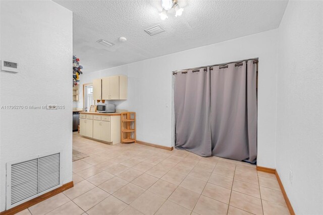 9240 Nautilus Dr, Cutler Bay, FL 33189 - interior space with light tile patterned floors, baseboards, a textured ceiling, and visible vents