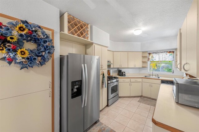 9240 Nautilus Dr, Cutler Bay, FL 33189 - kitchen featuring light countertops, open shelves, cream cabinetry, and stainless steel appliances