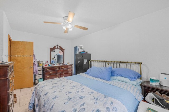 bedroom featuring light tile patterned floors and a ceiling fan