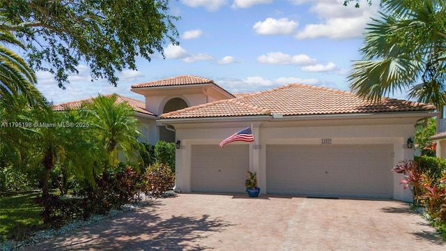 12307 NW 49th St, Coral Springs, FL 33076 - mediterranean / spanish-style house with stucco siding, an attached garage, decorative driveway, and a tiled roof