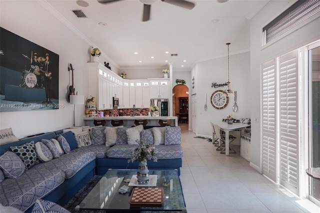 12307 NW 49th St, Coral Springs, FL 33076 - living room featuring a ceiling fan, light tile patterned flooring, arched walkways, ornamental molding, and baseboards