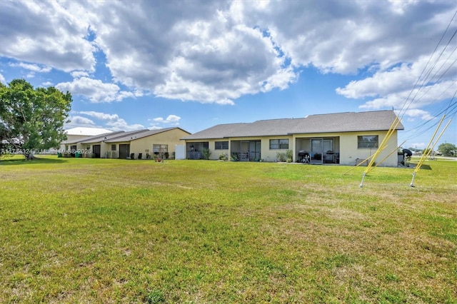 26136 Explorer St, Punta Gorda, FL 33983 - back of house with stucco siding and a yard