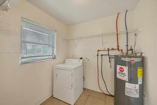 26136 Explorer St, Punta Gorda, FL 33983 - washroom featuring laundry area, washer / clothes dryer, light tile patterned floors, baseboards, and electric water heater