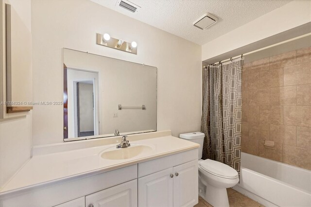 26136 Explorer St, Punta Gorda, FL 33983 - full bathroom with a textured ceiling, visible vents, vanity, toilet, and shower / tub combo with curtain
