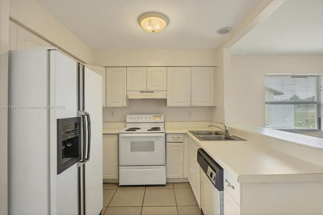 26136 Explorer St, Punta Gorda, FL 33983 - kitchen with a sink, white appliances, a peninsula, light tile patterned floors, and under cabinet range hood