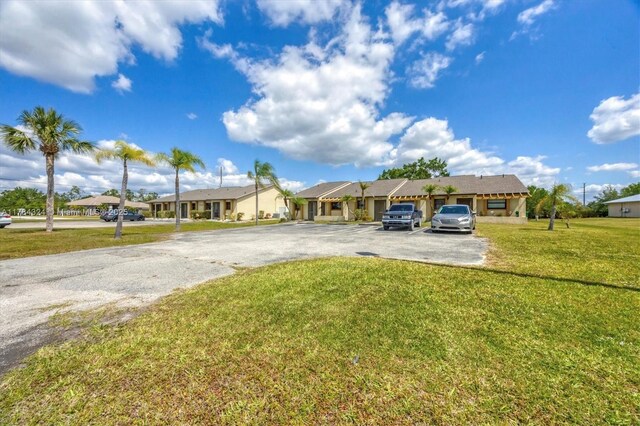 26136 Explorer St, Punta Gorda, FL 33983 - ranch-style house featuring uncovered parking, a residential view, and a front yard