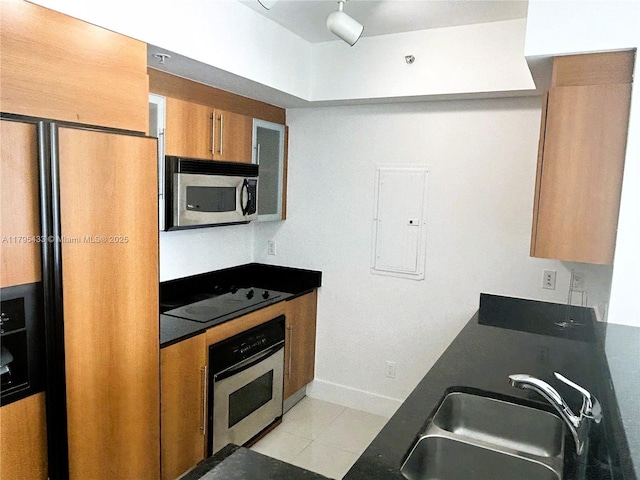 325 S Biscayne Blvd Unit 2917, Miami, FL 33131 - kitchen with appliances with stainless steel finishes, electric panel, brown cabinets, a sink, and baseboards