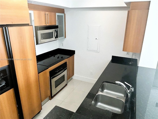 325 S Biscayne Blvd Unit 2917, Miami, FL 33131 - kitchen featuring appliances with stainless steel finishes, a sink, electric panel, brown cabinetry, and light tile patterned floors