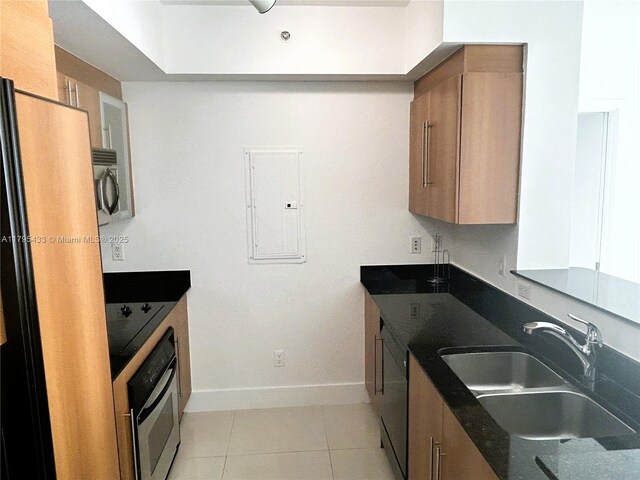 325 S Biscayne Blvd Unit 2917, Miami, FL 33131 - kitchen with stainless steel appliances, brown cabinets, electric panel, a sink, and baseboards