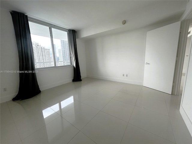 325 S Biscayne Blvd Unit 2917, Miami, FL 33131 - tiled empty room featuring baseboards and a smoke detector