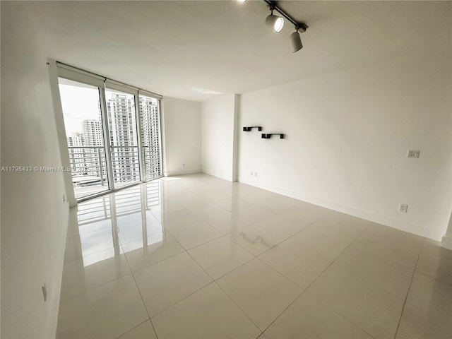 325 S Biscayne Blvd Unit 2917, Miami, FL 33131 - empty room with a wall of windows and tile patterned flooring