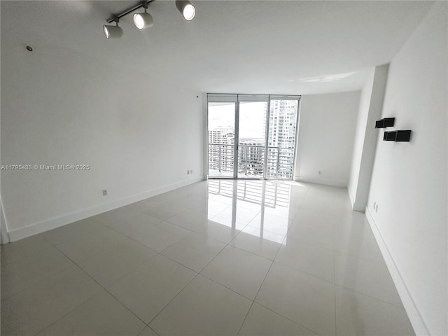 325 S Biscayne Blvd Unit 2917, Miami, FL 33131 - empty room featuring a wall of windows, baseboards, and tile patterned flooring