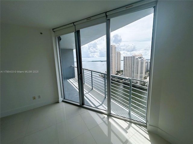 325 S Biscayne Blvd Unit 2917, Miami, FL 33131 - spare room featuring plenty of natural light, expansive windows, baseboards, and a water view