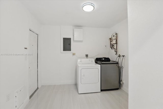 6800 Hope St, Hollywood, FL 33024 - washroom featuring baseboards, light tile patterned floors, washing machine and dryer, and electric panel