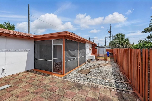 6800 Hope St, Hollywood, FL 33024 - back of property with a storage shed, a sunroom, an outbuilding, a patio area, and fence private yard
