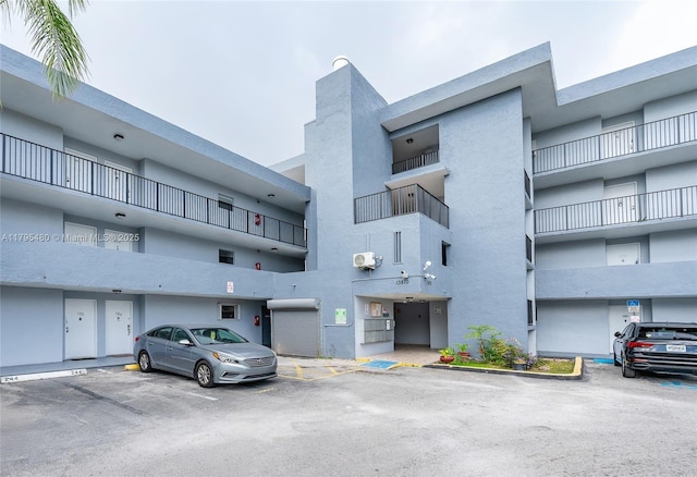 view of building exterior featuring uncovered parking