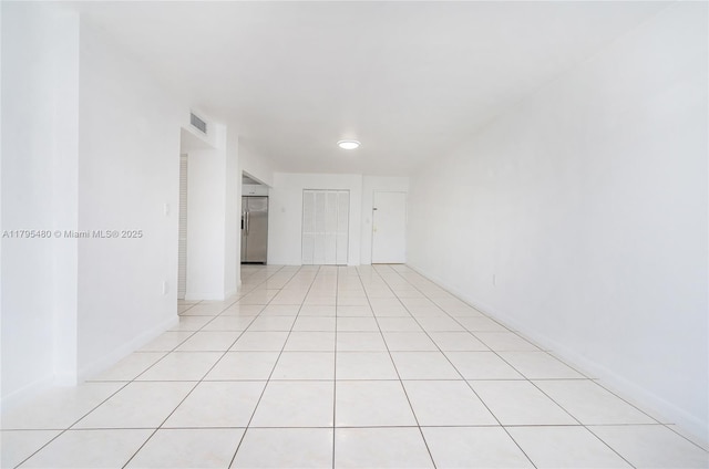 empty room featuring light tile patterned floors and visible vents