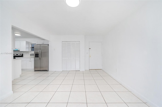 unfurnished living room featuring light tile patterned floors