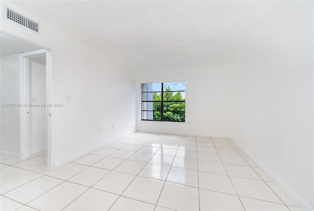 spare room with baseboards, visible vents, and light tile patterned floors