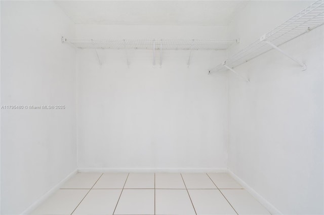 spacious closet with light tile patterned floors